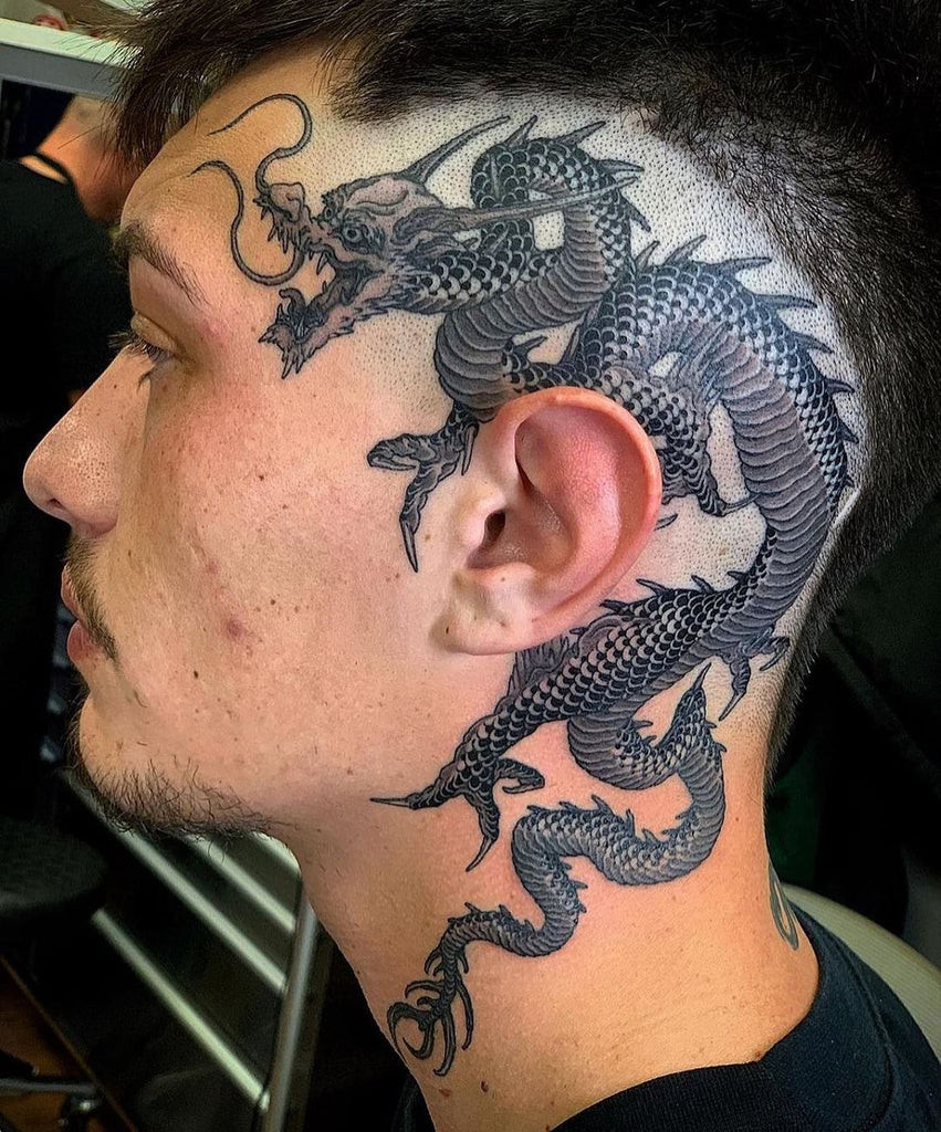 Japanese style face tattoo with wave and cloud motifs, a cool and culturally inspired design in black ink.