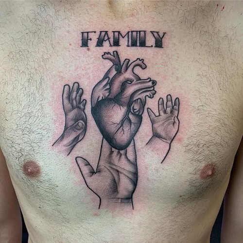 Large family crest tattoo on a man's chest, a bold and heartfelt family statement.