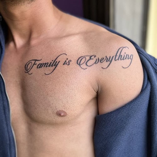 Elegant &quot;Family is Everything&quot; cursive tattoo on a man's wrist, a subtle yet meaningful family tattoo.