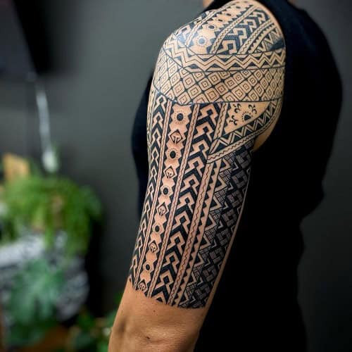 Filipino tribal tattoo on a man's chest, featuring geometric patterns and cultural motifs.