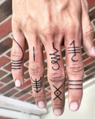 Finger tattoo of zodiac symbol, personal and meaningful symbol for men