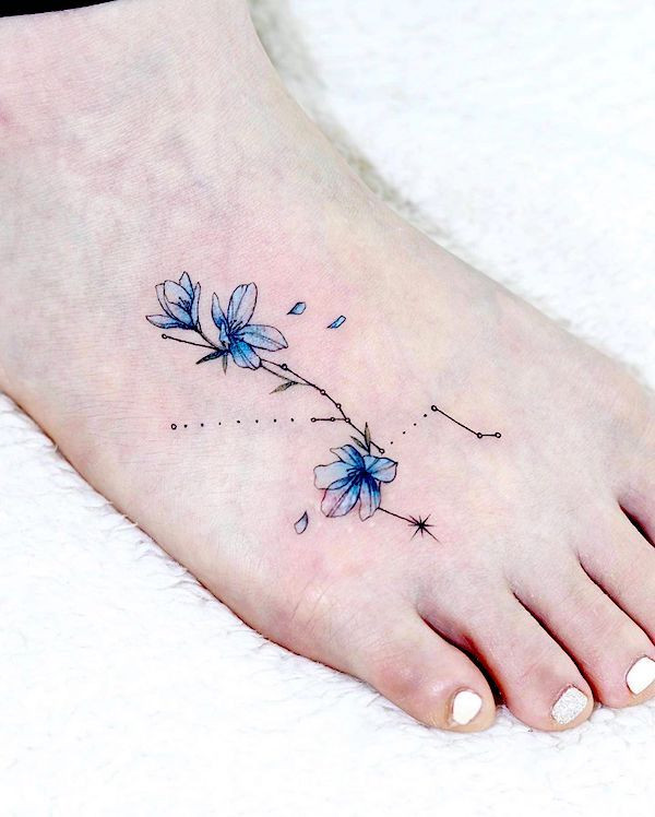 Floral foot tattoo, a bold and detailed floral design making a strong statement on the foot