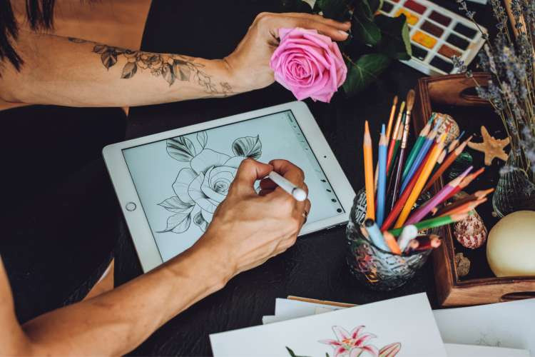 designing flower tattoo ideas on a tablet