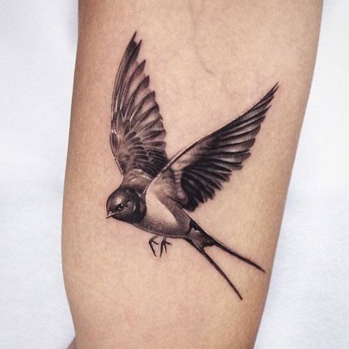 Dynamic flying bird tattoo for men, embodying freedom and limitless possibilities