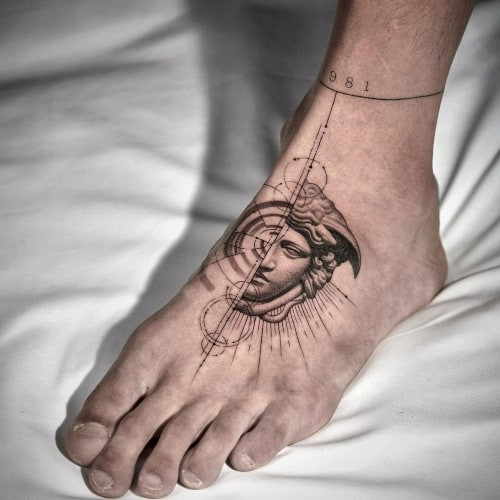 A foot tattoo with minimalist symbols on a man's ankle and foot, subtle