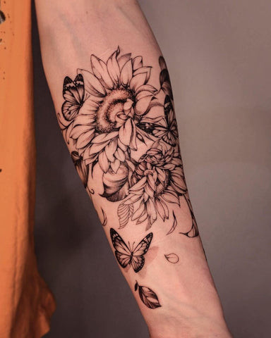 Vibrant watercolor forearm flower tattoo, symbolizing beauty and growth.