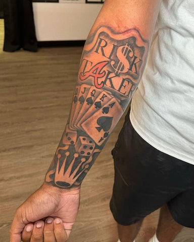 Freestyle forearm tattoo with hood-inspired designs, expressing individuality, creativity, and a unique personal style in ink.