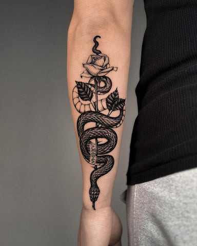 Forearm tattoo depicting a snake winding around a red rose, symbolizing temptation, transformation, and the duality of nature.