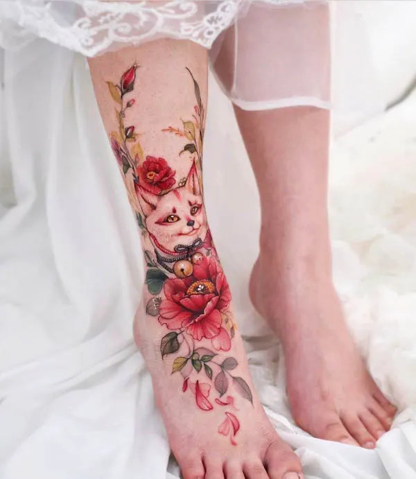 Fox and flowers foot tattoo extending to the calf, a vibrant and detailed design with a fantasy aesthetic