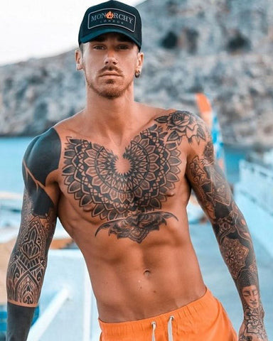 A clock and rose tattoo design on a man's front shoulder
