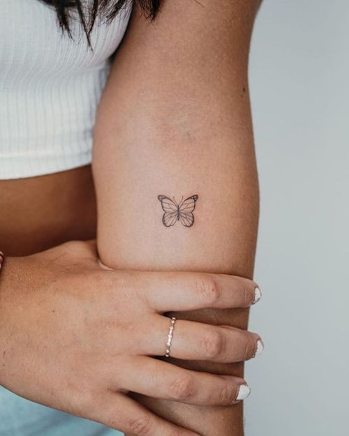 Butterfly outline tattoo on the wrist