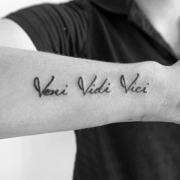 &quot;Veni Vidi Vici&quot; tattoo on wrist of a gentleman, representing ambition and conquest