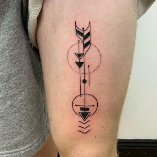 Geometric arrow tattoo showcasing an arrow design with clean geometric lines, symbolizing direction and focus.