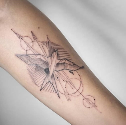 Geometric bird tattoo featuring a bird design, not specifically a hawk or owl, created with geometric shapes to symbolize freedom and aspiration.