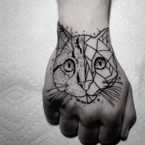 Geometric cat tattoo depicting a cat's face or body using geometric shapes, representing independence and mystery.