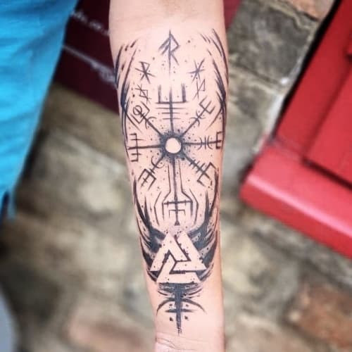 Geometric compass tattoo depicting a compass rose with geometric lines, symbolizing guidance and direction.