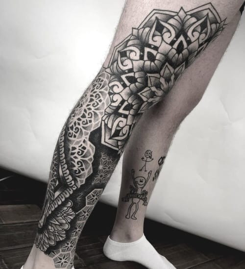 Geometric leg tattoo located on the leg, showcasing geometric patterns that can be easily covered or displayed, offering versatility.