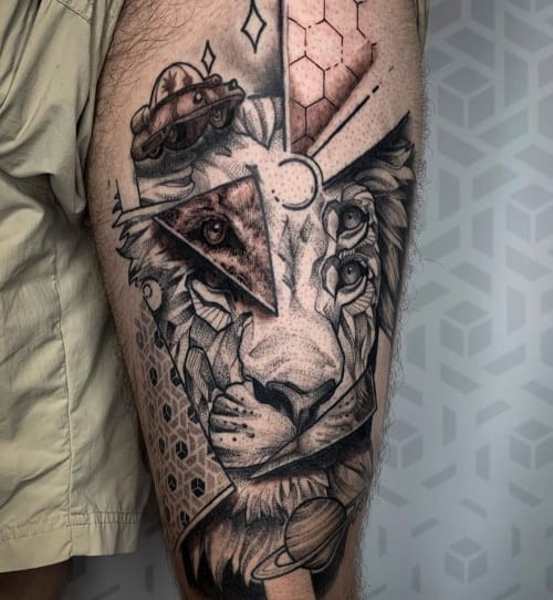 Geometric lion tattoo depicting a lion's head with sharp, geometric lines and angles, conveying power and majesty.