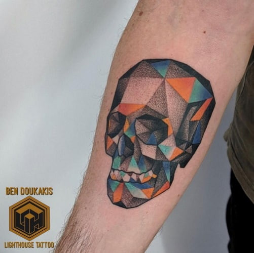 Geometric skull tattoo showcasing a skull design constructed from geometric shapes and lines, blending edginess with modern artistry.