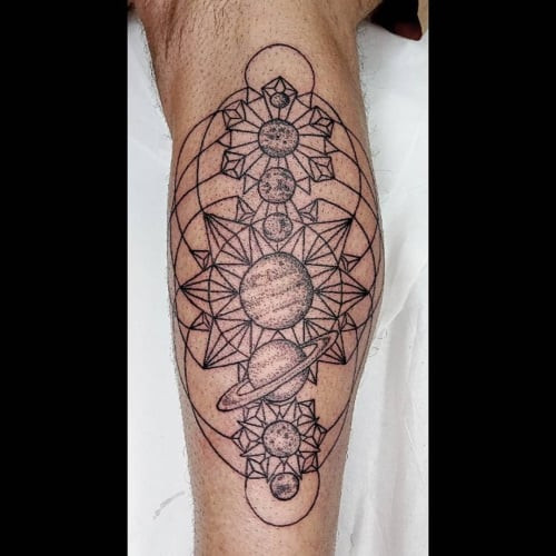 Geometric space tattoo showcasing celestial elements like stars and planets designed with geometric shapes, representing the vastness of space.