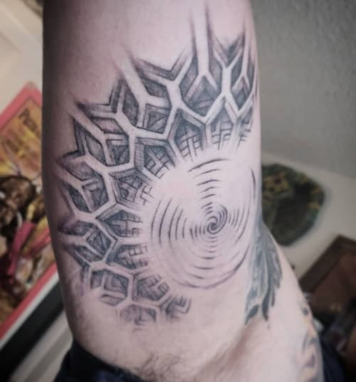 Geometric sun tattoo featuring a sun design with geometric rays and shapes, symbolizing enlightenment and positivity.