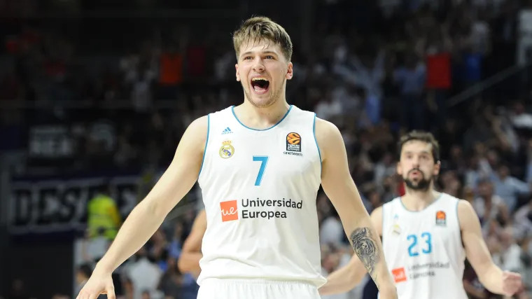 Luka Doncic playing for Real Madrid, displaying his tiger tattoo on his left forearm