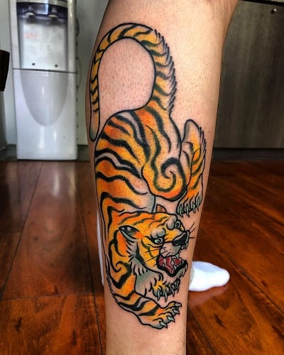 Regal gold tiger tattoo with auspicious symbolism