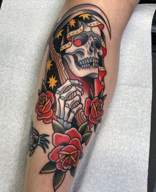 Black and grey grim reaper tattoo on a man's arm