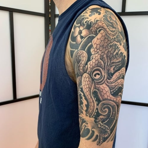 Two half sleeve tattoos on men, one with an upper arm half sleeve and another with a forearm half sleeve tattoo.