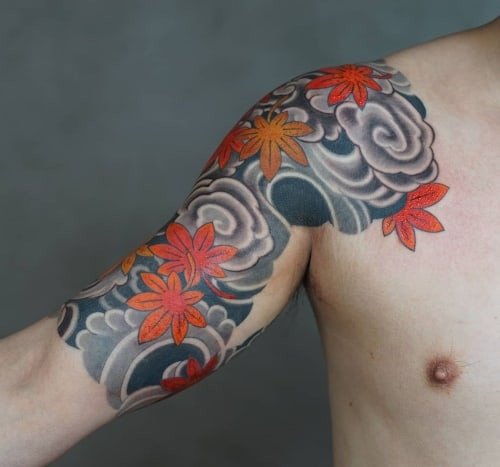 Half sleeve tattoo with tribal pattern on a man's arm