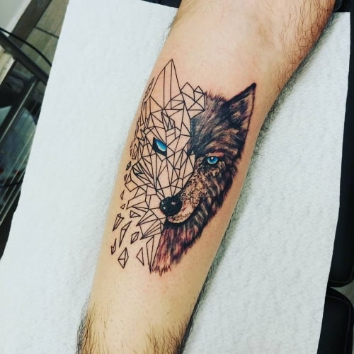 A half wolf tattoo on a man's arm, creatively combining half a realistic wolf with half a geometric wolf design, symbolizing duality of personality and abstract artistic expression.