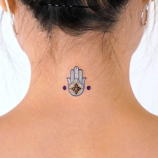 alt text: Intricate Hamsa hand tattoo with an eye in the palm, symbolizing protection and restored inner strength