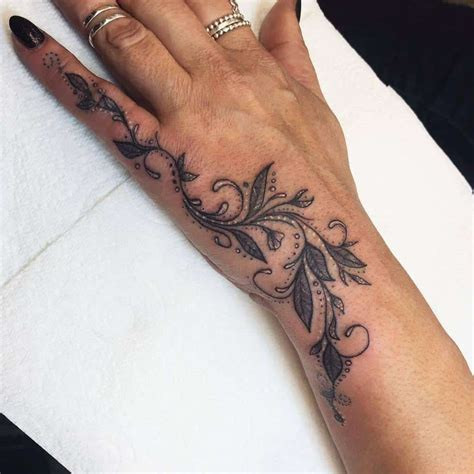 Delicate floral hand tattoo for women