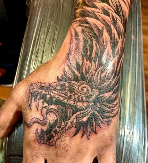 Hand tattoo with blackwork design on a man's hand