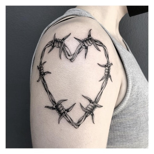 Two heart tattoos on men, one on the chest with a stylized heart and dagger and another on the shoulder with a geometric heart pattern.