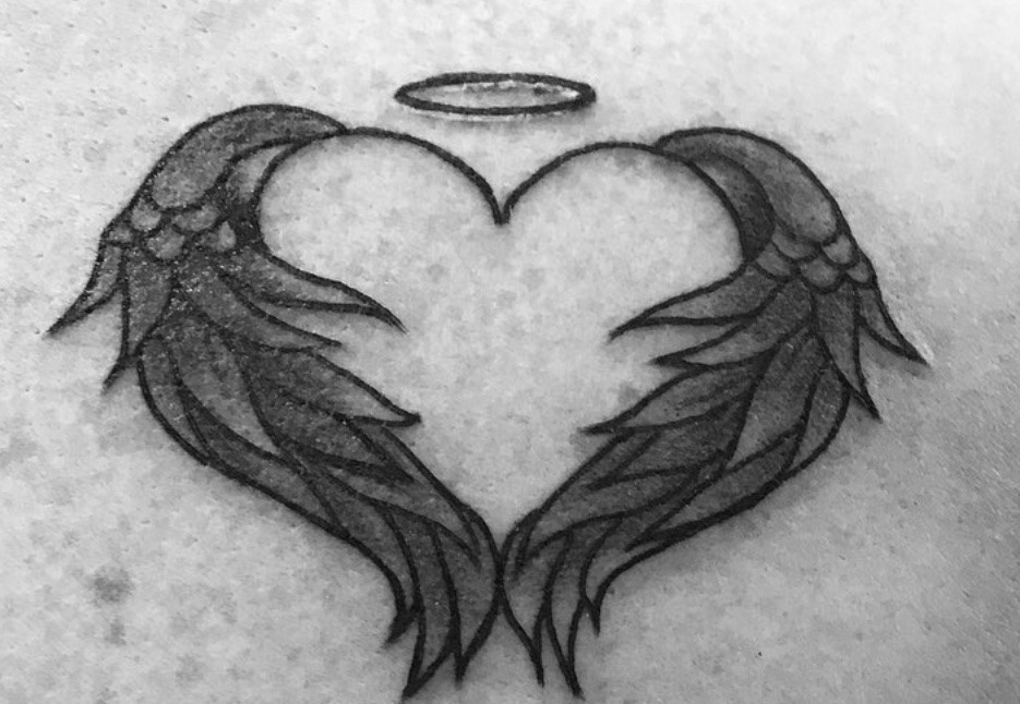 Heart and angel wings tattoo, emphasizing love, passion, and emotional connection.