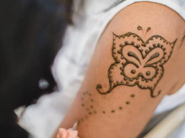 Detailed henna tattoo patterns covering hand and wrist, showcasing traditional henna artistry.