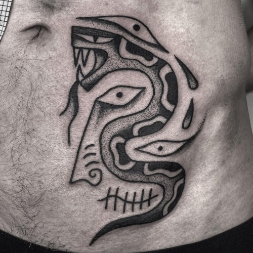 A hip tattoo with geometric design on a man's side hip, modern and concealed