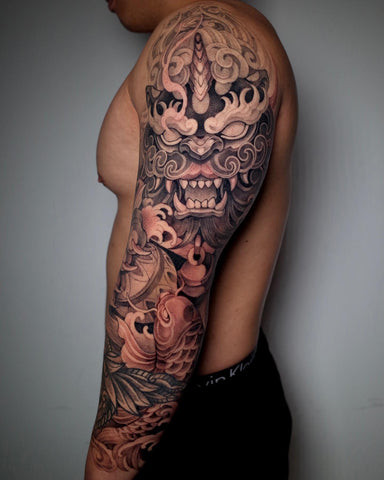 Foo Dog Tattoo on Forearm with Detailed Scales and Fierce Expression