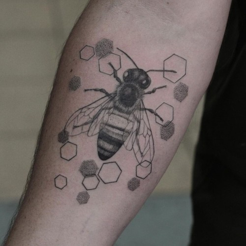 Honeycomb pattern tattoo sleeve on a man's arm