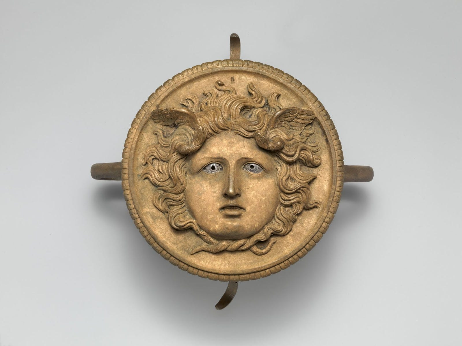 Bronze ornament from a chariot pole depicting Medusa with wings and snakes in her hair, 1st-2nd century CE