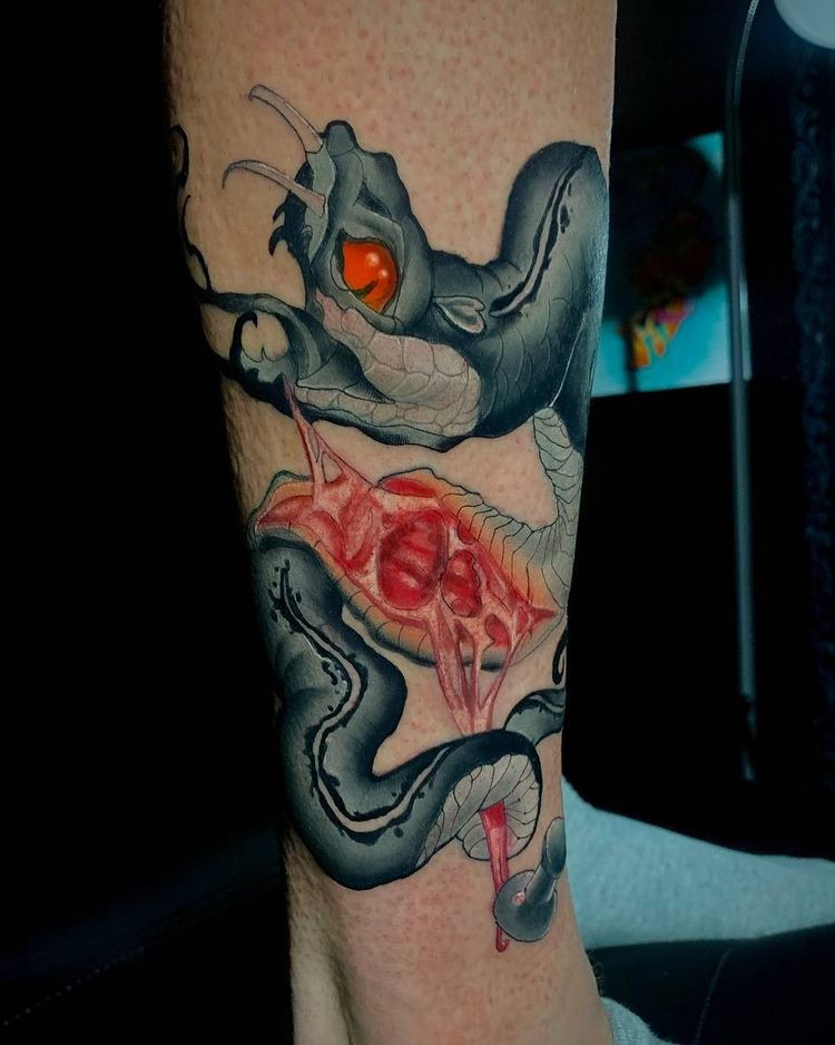 badass snake tattoo wrapping around arm