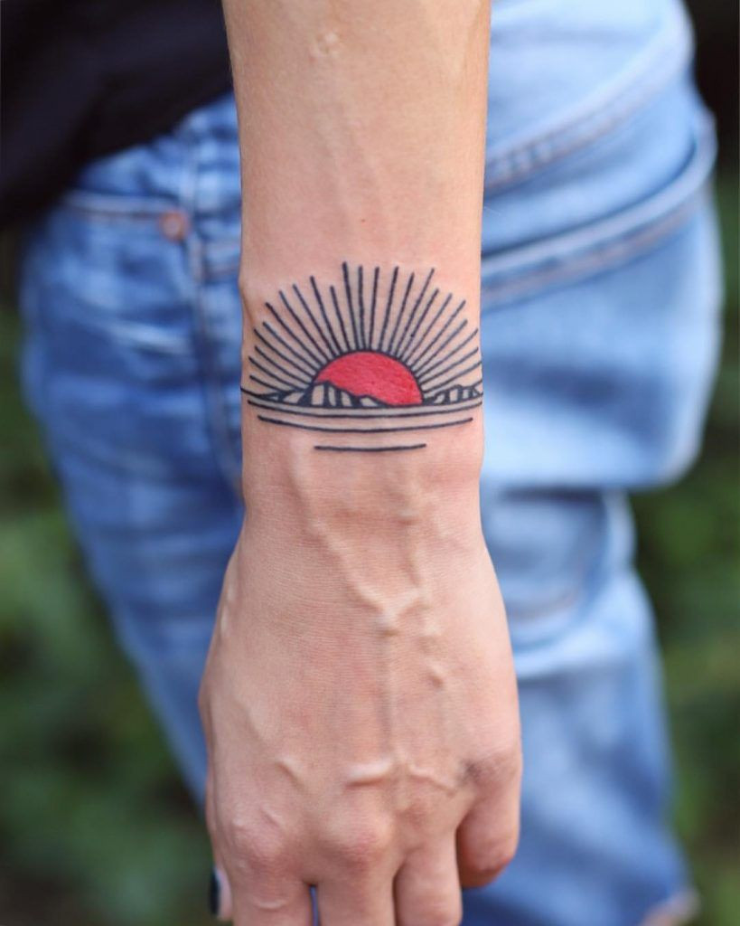 Dandelion wish wrist tattoo symbolizing resilience and spreading positivity