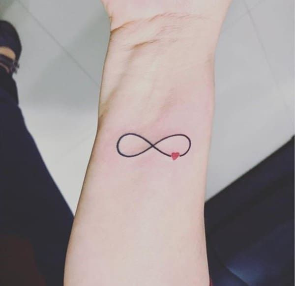 Simple infinity symbol wrist tattoo, representing eternity and endless possibilities for women