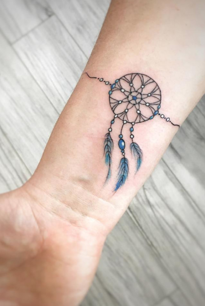 Intricate dreamcatcher wrist tattoo, blending beauty with cultural symbolism for women