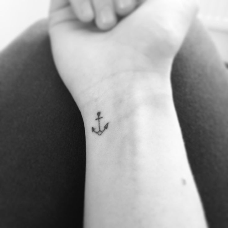 Elegant small anchor wrist tattoo, a symbol of stability, hope, and grounding for women