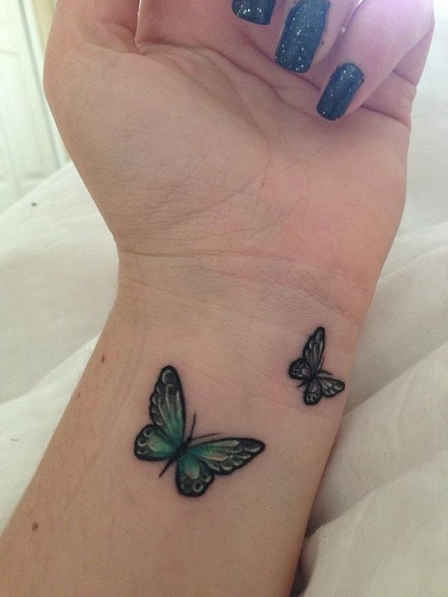 Whimsical butterfly wrist tattoo, symbolizing transformation, beauty, and personal growth for women