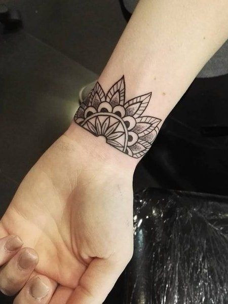 Intricate mandala wrist tattoo, symbolizing harmony, unity, and spirituality for women