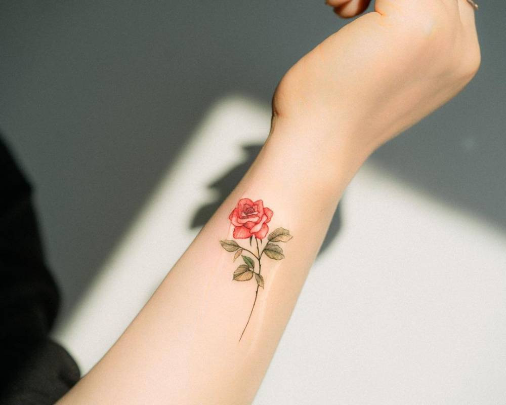 Watercolor style flower wrist tattoo for women