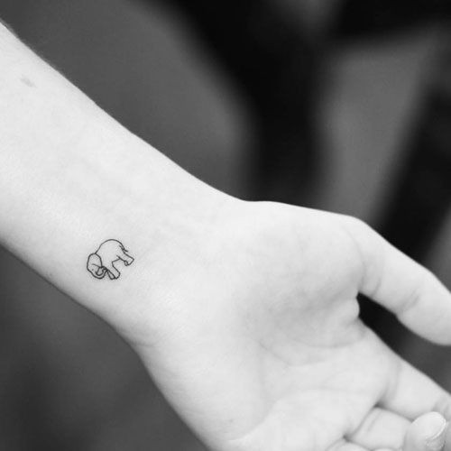 Tiny elephant outline wrist tattoo for women